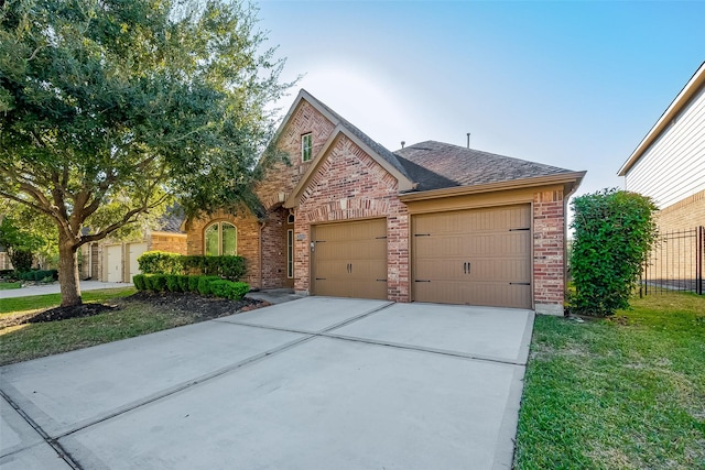 view of front of home with a garage and a front lawn