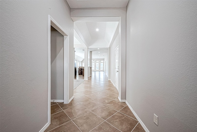 hall with tile patterned floors