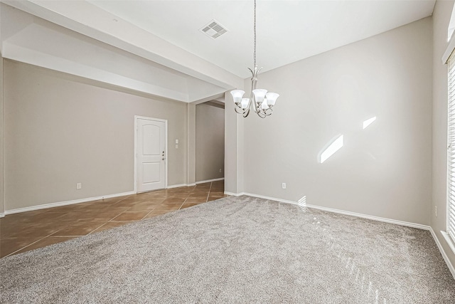 empty room with carpet flooring and a chandelier