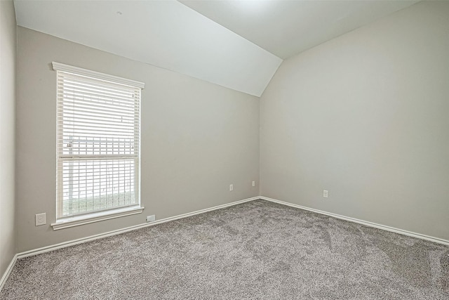 empty room with carpet and vaulted ceiling