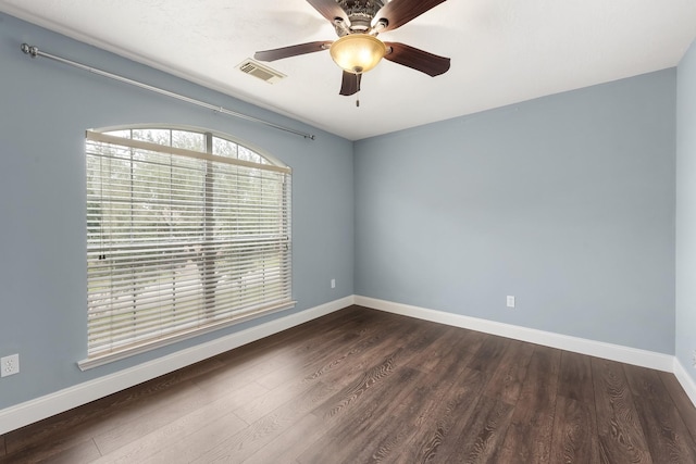 unfurnished room with dark hardwood / wood-style floors and ceiling fan