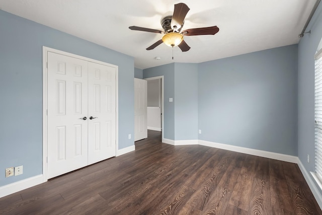 unfurnished bedroom featuring a closet, ceiling fan, and dark hardwood / wood-style flooring