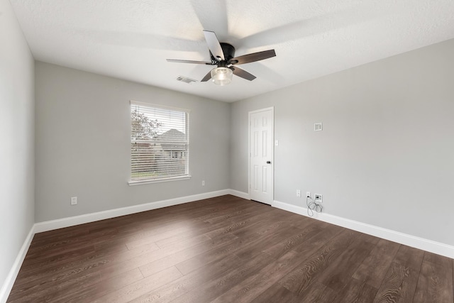 unfurnished room with a textured ceiling, dark hardwood / wood-style flooring, and ceiling fan