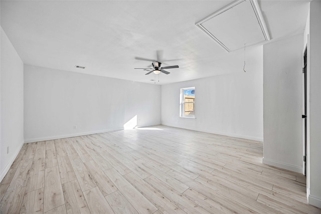 spare room with light wood-type flooring and ceiling fan