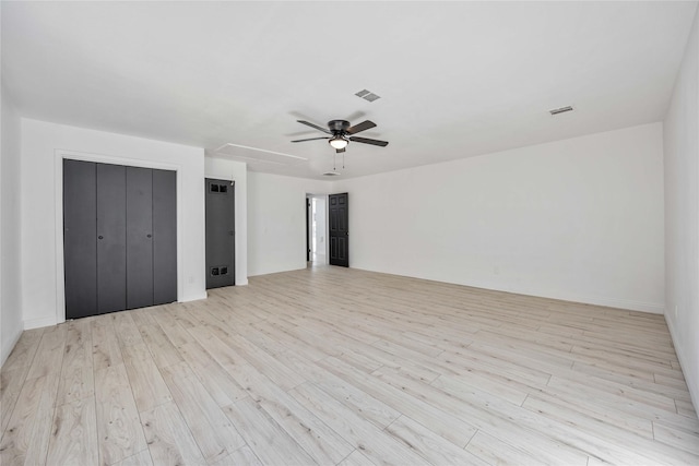 unfurnished bedroom with ceiling fan and light wood-type flooring