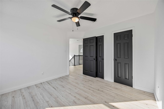 unfurnished room featuring ceiling fan and light wood-type flooring