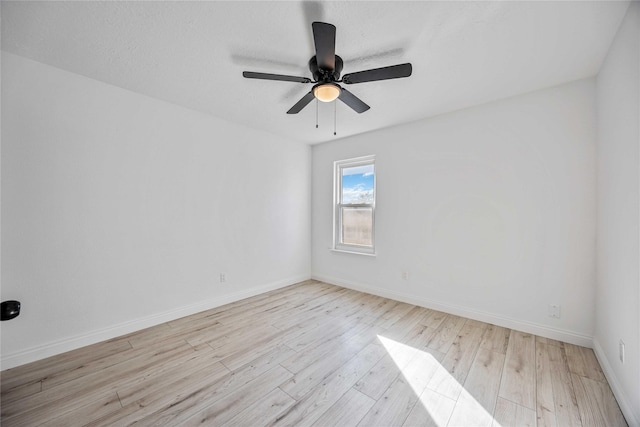 unfurnished room featuring ceiling fan, light hardwood / wood-style flooring, and a textured ceiling