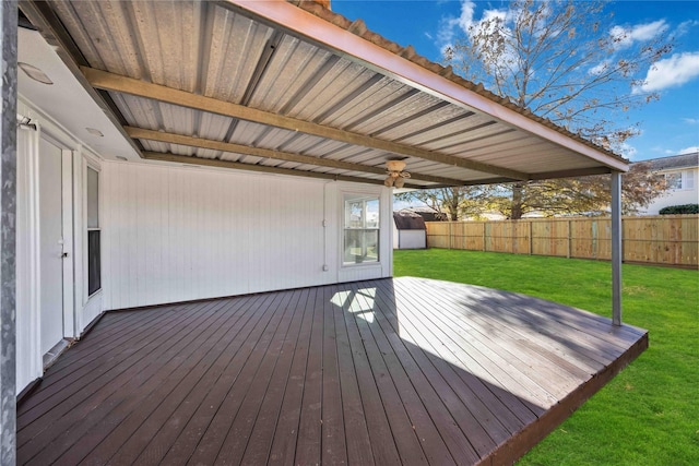 wooden terrace featuring a lawn