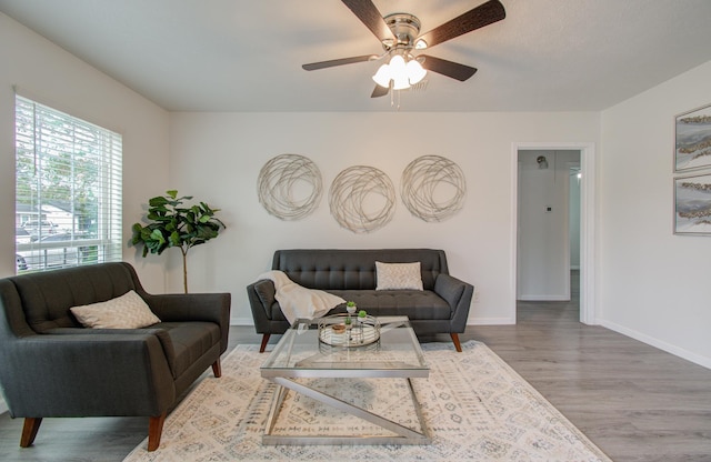 living room with hardwood / wood-style floors and ceiling fan