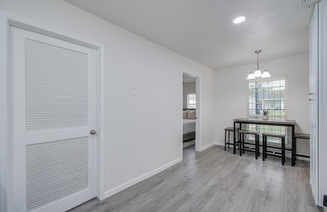 dining room with a chandelier and light wood-type flooring