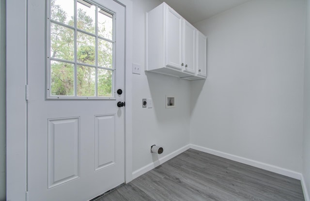 washroom featuring hardwood / wood-style flooring, electric dryer hookup, cabinets, and hookup for a washing machine