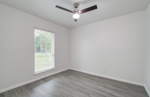 spare room with ceiling fan and wood-type flooring