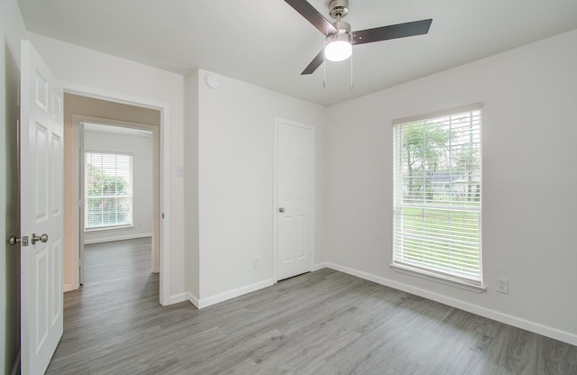 unfurnished room featuring ceiling fan and light wood-type flooring