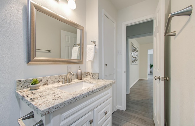 bathroom with vanity and hardwood / wood-style flooring