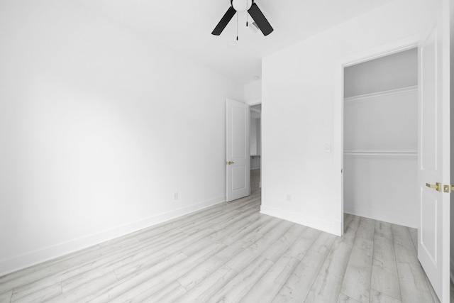 unfurnished bedroom featuring ceiling fan, light wood-type flooring, and a closet