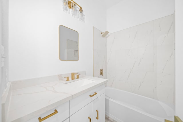 bathroom featuring tiled shower / bath combo and vanity