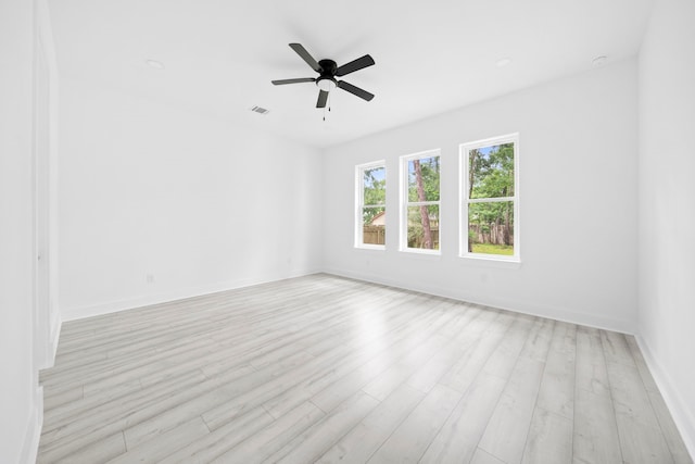 empty room featuring light hardwood / wood-style flooring and ceiling fan