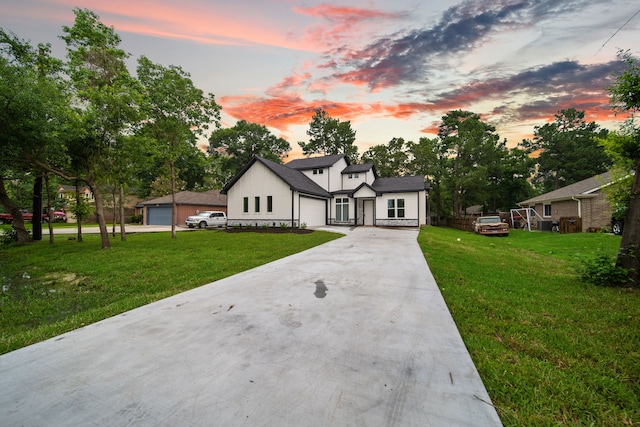 view of front of property with a lawn and a garage