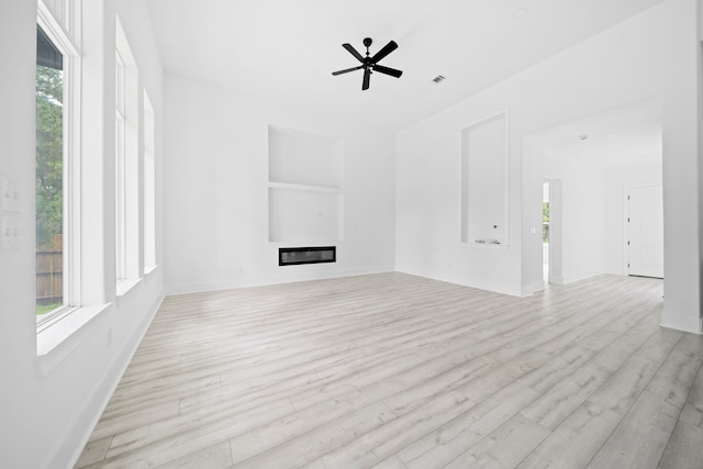 unfurnished living room featuring ceiling fan and light hardwood / wood-style flooring