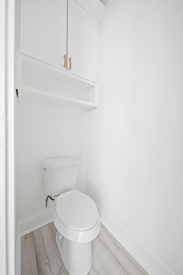 bathroom featuring toilet and hardwood / wood-style flooring