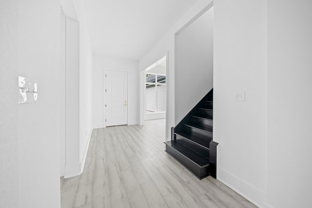 corridor with light wood-type flooring