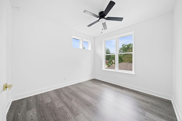 spare room with dark hardwood / wood-style flooring and ceiling fan