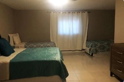 bedroom featuring light tile patterned floors