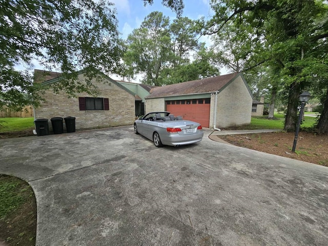 711 N Hyannis Port St, Crosby, TX 77532 - view of property exterior featuring brick siding, driveway, and an attached garage