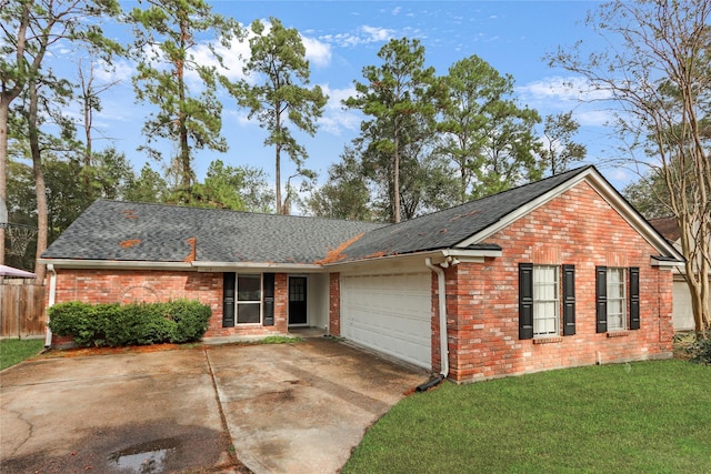 ranch-style home with a garage and a front yard