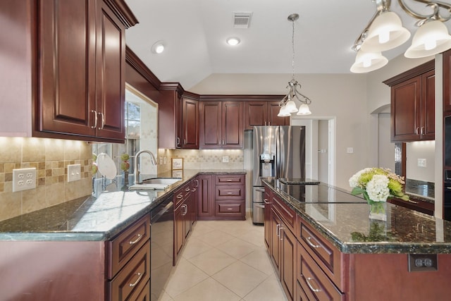 kitchen featuring appliances with stainless steel finishes, decorative light fixtures, tasteful backsplash, and sink