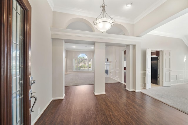 entryway with dark hardwood / wood-style flooring and ornamental molding