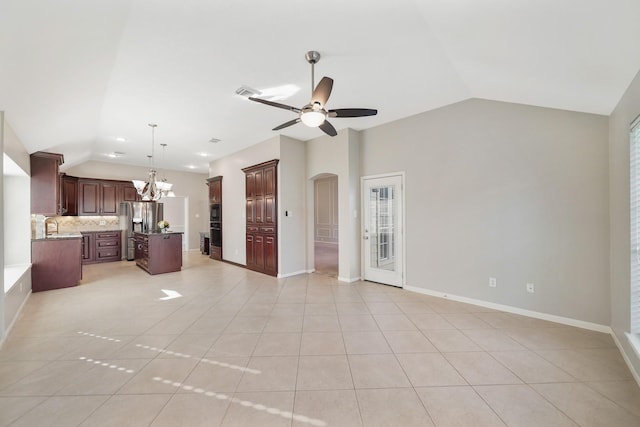 kitchen featuring decorative backsplash, stainless steel refrigerator with ice dispenser, dark brown cabinetry, light tile patterned floors, and lofted ceiling