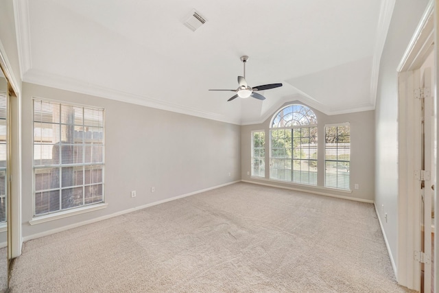 carpeted spare room featuring vaulted ceiling, ceiling fan, and crown molding