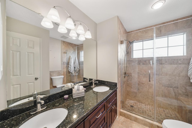 bathroom with vanity, toilet, and a shower with shower door