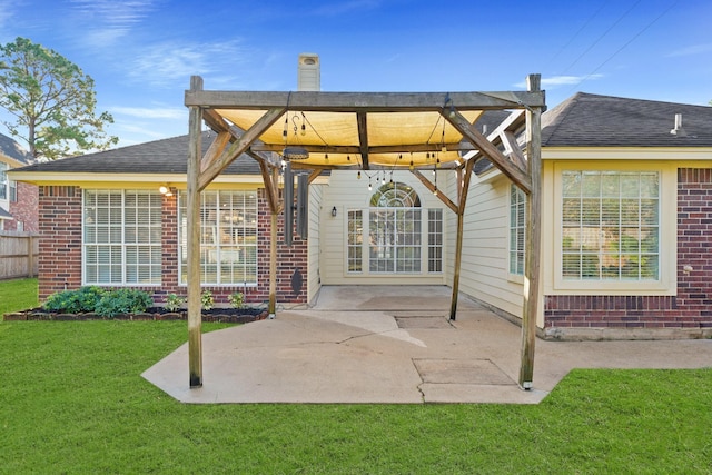 rear view of property with a lawn, a pergola, and a patio