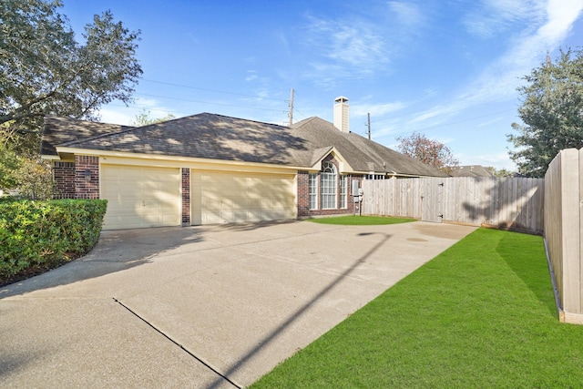 ranch-style home with a front yard and a garage