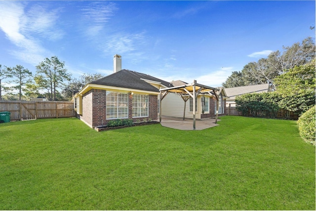 back of house featuring a pergola, a patio, and a lawn