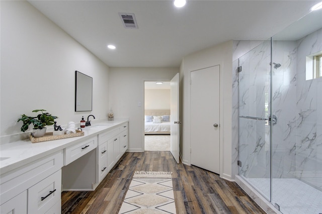 bathroom with vanity, hardwood / wood-style flooring, and an enclosed shower