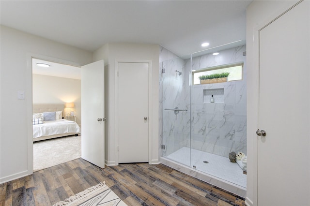 bathroom with hardwood / wood-style floors and an enclosed shower