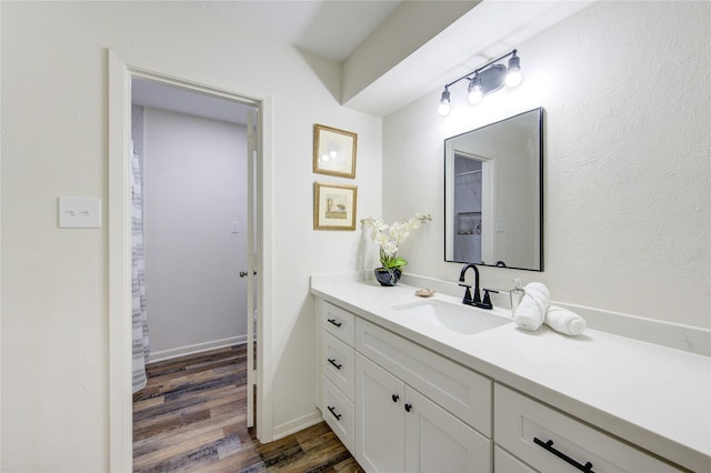 bathroom featuring vanity and hardwood / wood-style flooring