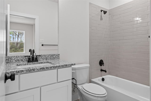 full bathroom featuring vanity, toilet, and tiled shower / bath