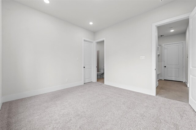 unfurnished bedroom featuring light colored carpet