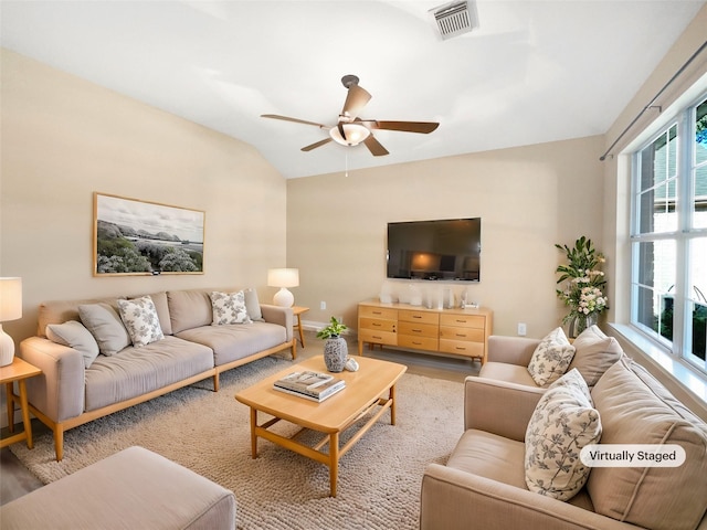 living room featuring hardwood / wood-style floors, vaulted ceiling, and ceiling fan