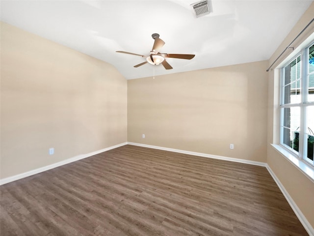 empty room with vaulted ceiling, ceiling fan, and dark wood-type flooring