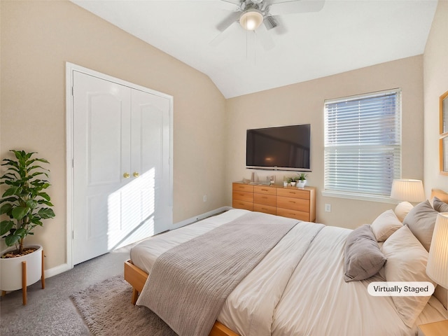 bedroom featuring carpet flooring, multiple windows, ceiling fan, and lofted ceiling