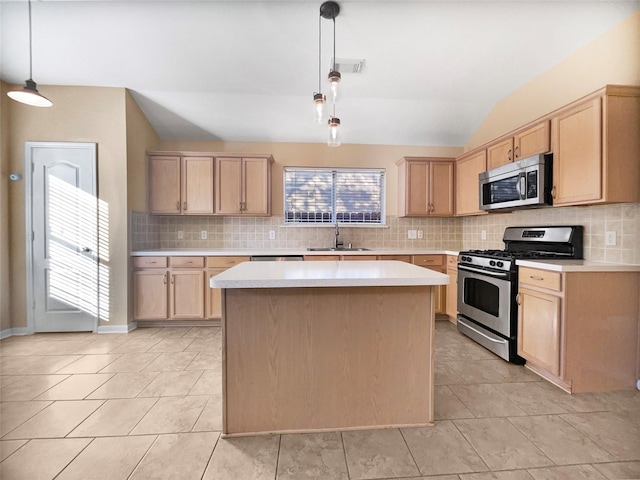 kitchen with decorative backsplash, appliances with stainless steel finishes, sink, a kitchen island, and hanging light fixtures