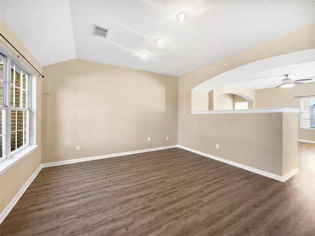 empty room featuring ceiling fan, lofted ceiling, and dark wood-type flooring