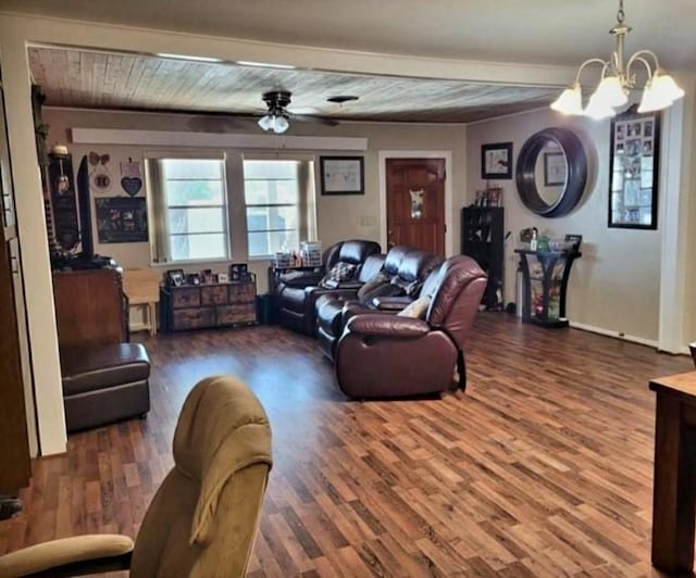 living room with ceiling fan with notable chandelier, beam ceiling, and dark hardwood / wood-style flooring