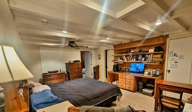 carpeted bedroom with built in desk and beamed ceiling