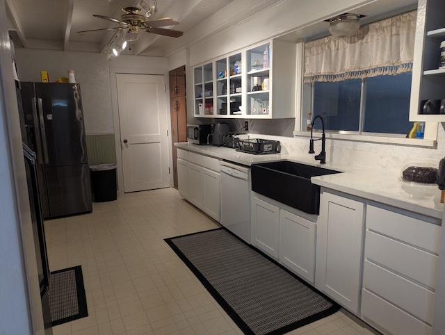 kitchen featuring sink, white cabinets, ceiling fan, white dishwasher, and black fridge